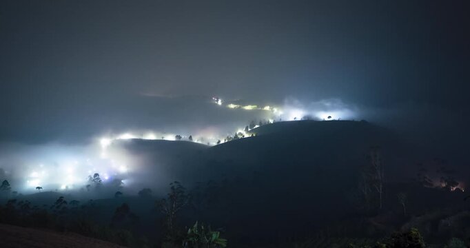 Timelapse of a rural town blanketed by the fog at night