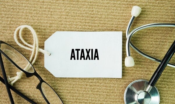 Stethoscope and paper tag with the word Ataxia. inability to coordinate voluntary muscle movements, resulting in clumsy or unsteady actions