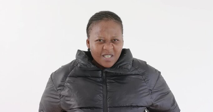 High-speed photography for dynamic scenes, wearing black puffer jacket, woman looking directly at ca