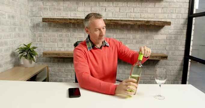 Lifestyle videos indoor of people doing activities at office, man in red sweater smelling wine in gl