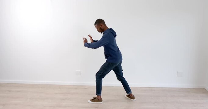 Man practicing martial arts in living room, focusing on balance and technique
