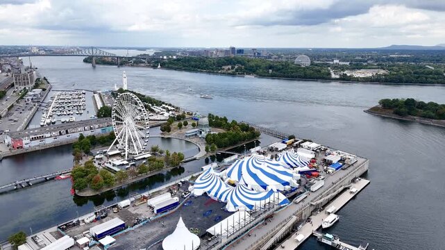 Cirque du Soleil blue-white tent at Montreal Old Port with city skyline in background. 24th of August 2025 drone flight