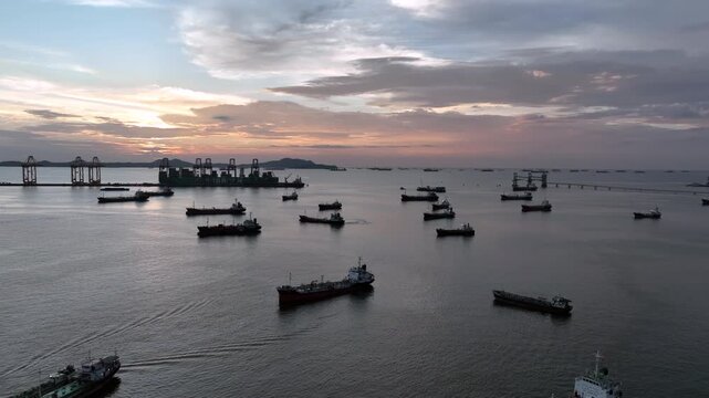 Aerial view oil and gas tanker ship offshore parking in sea, Crude oil tanker ship and LPG tanker ship offshore in bay at sunset, Silhouette oil and gas tanker ship.