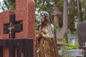 Fototapeta premium Ancient European cemetery with stone angels and historic tombstones