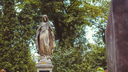 Fototapeta premium Ancient European cemetery with stone angels and historic tombstones