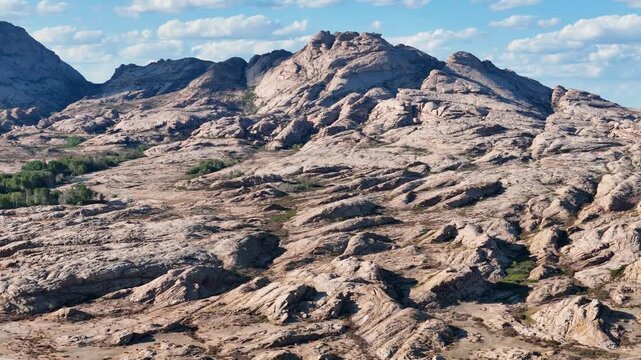 4K panoramic drone view of Bektau-Ata granite massif, blue sky, Kazakhstan