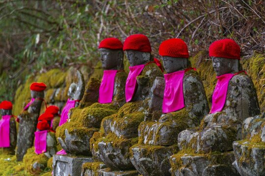 Jizo statues with red caps, protective deities for deceased children, Kanmangafuchi Abyss, Nikko, Japan