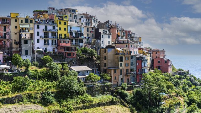 The village of Corniglia with its nested pastel-coloured houses built into the hillside, Corniglia, Cinque Terre, Ligurian Coast, Liguria, Italy
