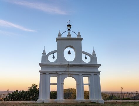 Bell tower of the chapel Ermita Reina de los &Aacute;ngeles, at sunset, Al&aacute;jar, Huelva, Spain