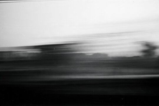 Abstract black and white photocopy texture with horizontal motion blur, grain and noise, distorted monochrome background for experimental print and graphic design