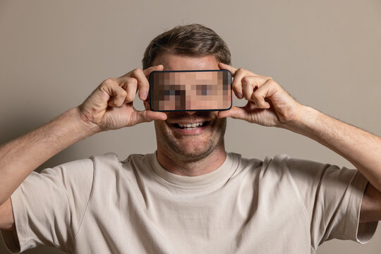 Anonymous identity and digital privacy concept with face hidden by phone