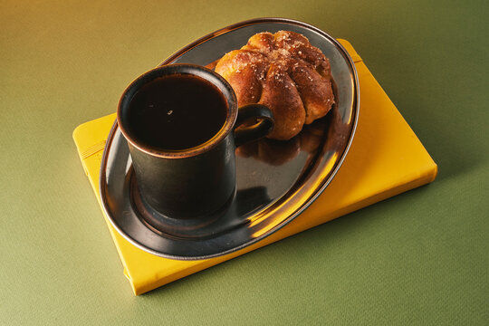 Black Coffee Mug with Sugared Pastry on Silver Tray
