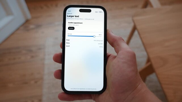 The text size is increased and the layout reflows instead of cutting the content off. Point of view shot with the phone held in the hand. Useful for readable design at every age.