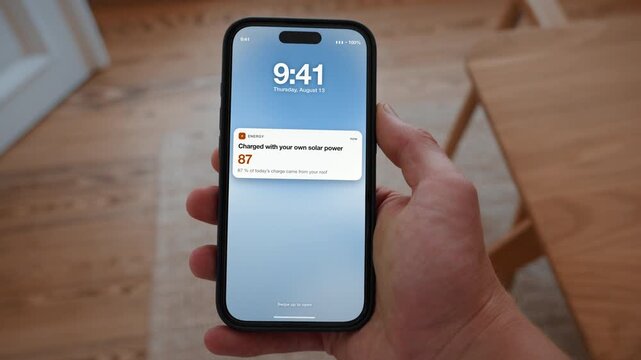 A notification reports that the car was charged with power from the roof, shown in percent. Point of view shot with the phone held in the hand. Useful for selling home solar systems.