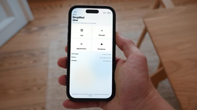 A simplified view offers four large tiles instead of a crowded menu on the phone. Point of view shot with the phone held in the hand. Useful for designing for older people.