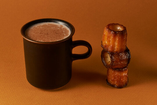 Hot Chocolate in Dark Mug with Canel&eacute; Pastry