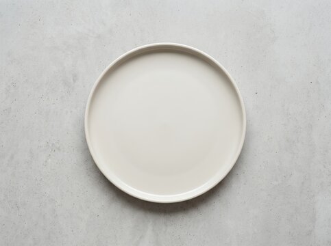 Minimalist White Plate on a Textured Gray Background.