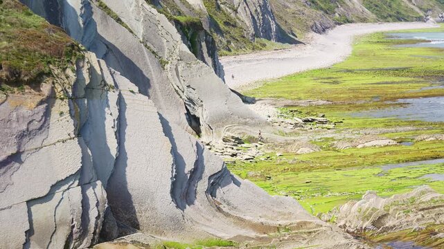 Layered flysch cliff rock formations on the beach coast in Spain