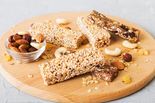 Various granola bars on table background. Cereal granola bars. Superfood breakfast bars with oats, nuts and berries, close up. Superfood concept