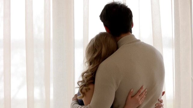 Couple hug in kitchen, intimate love with care, bonding and happy connection. Young man woman together with embrace, memory or anniversary in marriage, date home. lovers husband wife. relationship