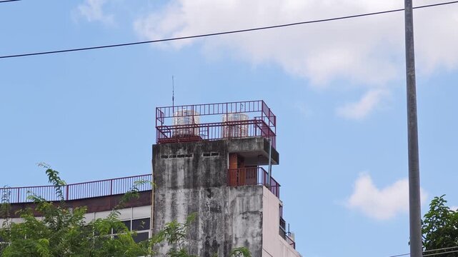  Rooftop water storage tanks installed on top of a residential building.