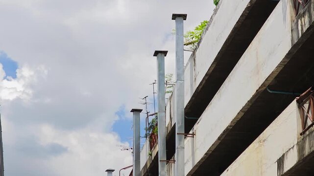  Exterior view of a kitchen exhaust vent pipe on a building wall for smoke ventilation.