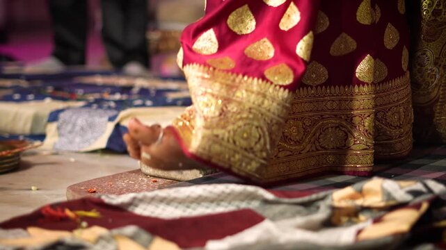 Indian bride performing traditional wedding ritual in Delhi with ornate saree