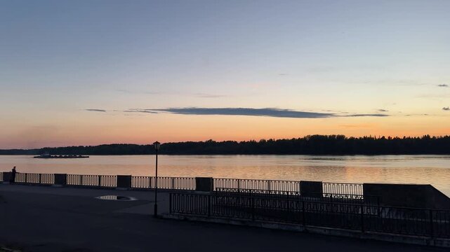 Dusk falls over an autumn river and forest, golden leaves reflecting in calm water, soft twilight glow, quiet and serene, candid authentic life moment in nature today.