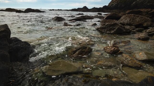 Timelapse of tide going out in a rocky Cornish cove. Coombe Beach near Fowey, Cornwall UK