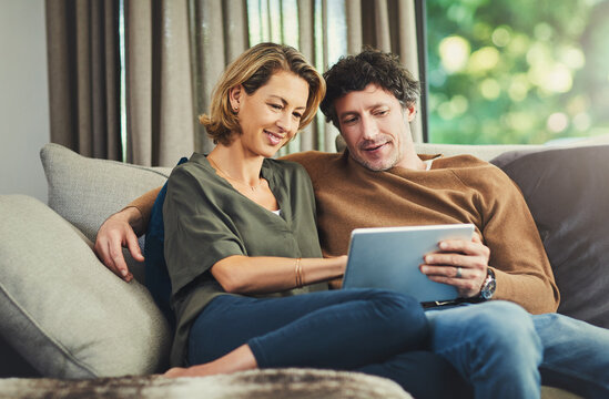 Relax, subscription and tablet with couple on sofa in living room of home for membership signup. App, download and search with mature people in apartment together for streaming service options