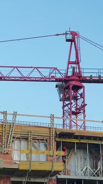 Residential construction site recorded as a vertical video taken on mobile device as user generated content. Buildings, cranes, and structural elements show ongoing housing development in urban area.