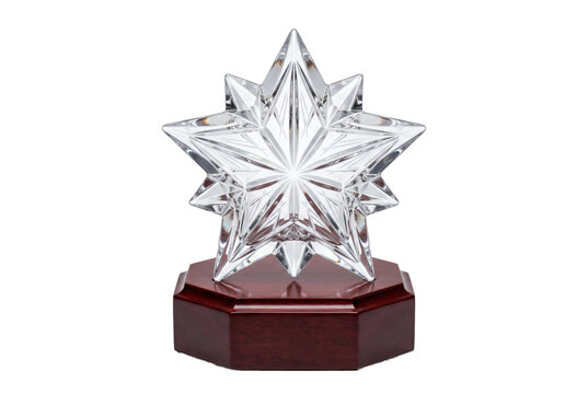 Sparkling crystal star trophy award on transparent background, multifaceted clear glass star mounted on dark polished mahogany wooden pedestal. Prestigious ceremony honors achievement background.