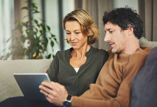 Digital, streaming and tablet with couple on sofa in living room of home for subscription signup. App, download and relax with mature people in apartment together to search for membership options