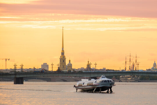 hydrofoil vessel travelling along the Neva River with the Peter and Paul Fortress and Annunciation Bridge in the background in Saint Petersburg.  Russia