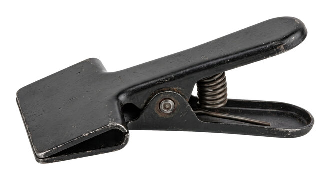 Old weathered black metal spring clamp with visible rust and scratches, isolated on a clean white background