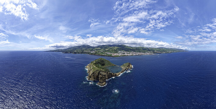 Aerial view of Ilheu de Vila Franca do Campo, a volcanic islet with a circular crater lake, surrounded by the deep blue Atlantic Ocean, Vila Franca do Campo, Azores, Portugal.
