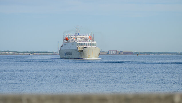 Helsing?r, Denmark - June 30 2026: Oresundslinjen ferry sailing away across wide blue sound.