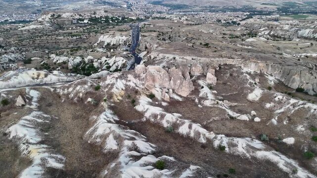 Volcanic valley with tuff rocks and winding road near Urgup in Cappadocia, Turkey.