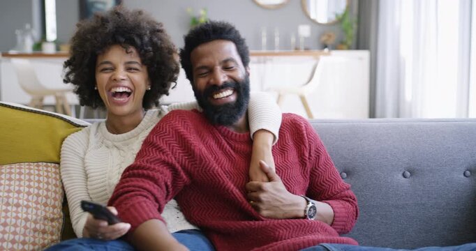 Bonding, happy or couple with watching tv, home entertainment or series binge on weekend break. Laugh, movie streaming or black people with remote, romantic connection or show subscription in house.