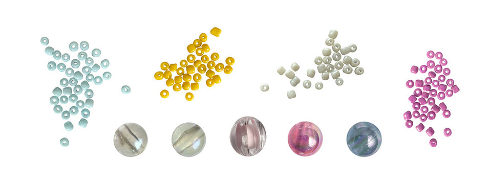 Isolated colorful seed beads and translucent round beads in blue, yellow, white and pink, real photographed craft elements isolated for jewelry making, collage, scrapbooking and creative designs