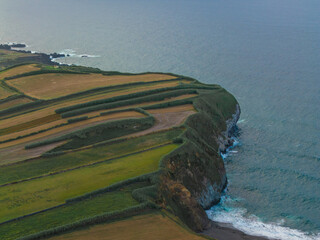 Coastal cliff with patchwork fields above the Atlantic Ocean, Azores © Pedro
