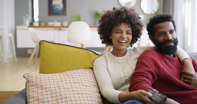 Bonding, smile or couple with watching tv, home entertainment or series binge on weekend break. Happy, movie streaming or black people with remote, romantic connection or show subscription in house.