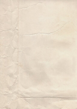 Aged ivory paper background with cracks, folds, creases and worn imperfections, real scanned vintage texture for collage, scrapbooking, ephemera, stationery and distressed designs