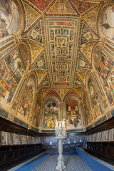 Obraz premium Antique choir books displayed in wooden cabinets in the famous Piccolomini Library, inside the Siena Cathedral (Duomo di Siena) in Tuscany, Italy. Built in the late 15th century (starting in 1492).