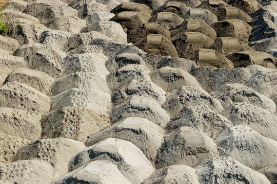 Aerial view of numerous sand piles arranged in rows at a construction site in Belgrade, City of Belgrade, Serbia.