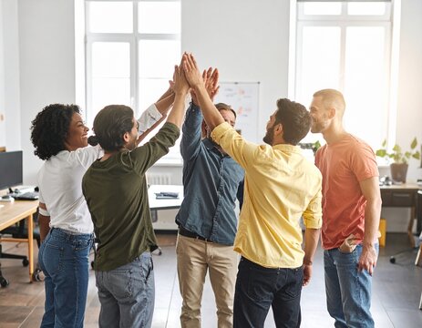 Colleagues celebrating a completed project with a relaxed high five