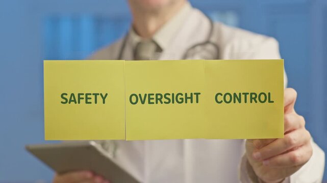 Male doctor in a white coat showing yellow sticky notes with the words safety, oversight, and control, representing the ethical principles for artificial intelligence in modern healthcare
