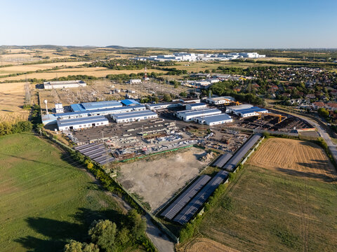 Aerial view of power grid and substation near battery factory in God, Hungary
