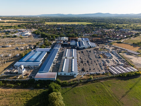 Aerial view of substation and power lines near battery factory in God, Hungary