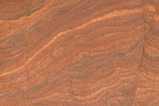 Warm, earthy tones ripple across the surface